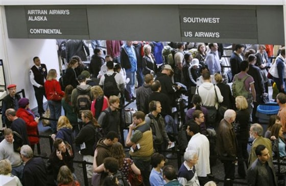 Travelers wait to enter terminals Dec. 21, 2009, at the San Francisco International Airport in San Francisco. Forecasts for higher fares and crowded planes suggest travelers should book their 2010 holiday plans now.